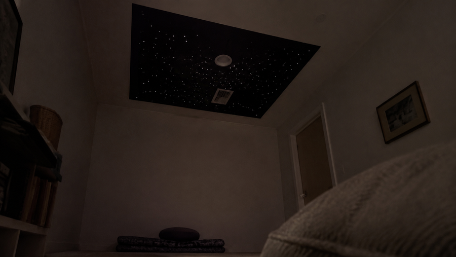 Bedroom star ceiling installed as a defined rectangular feature zone above the bed
