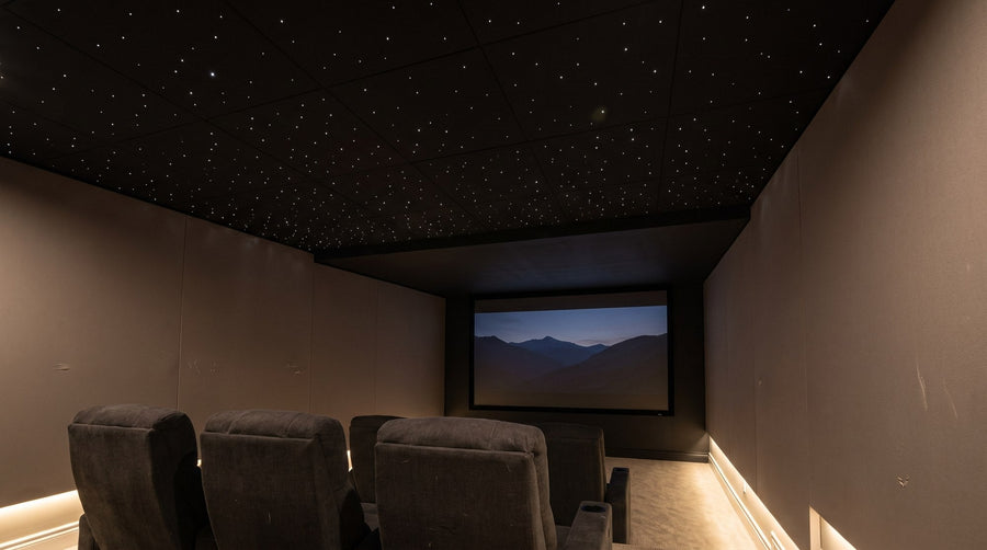 AI-generated design concept of a home theater with a subtle white star ceiling above the seating and a dark projection screen
