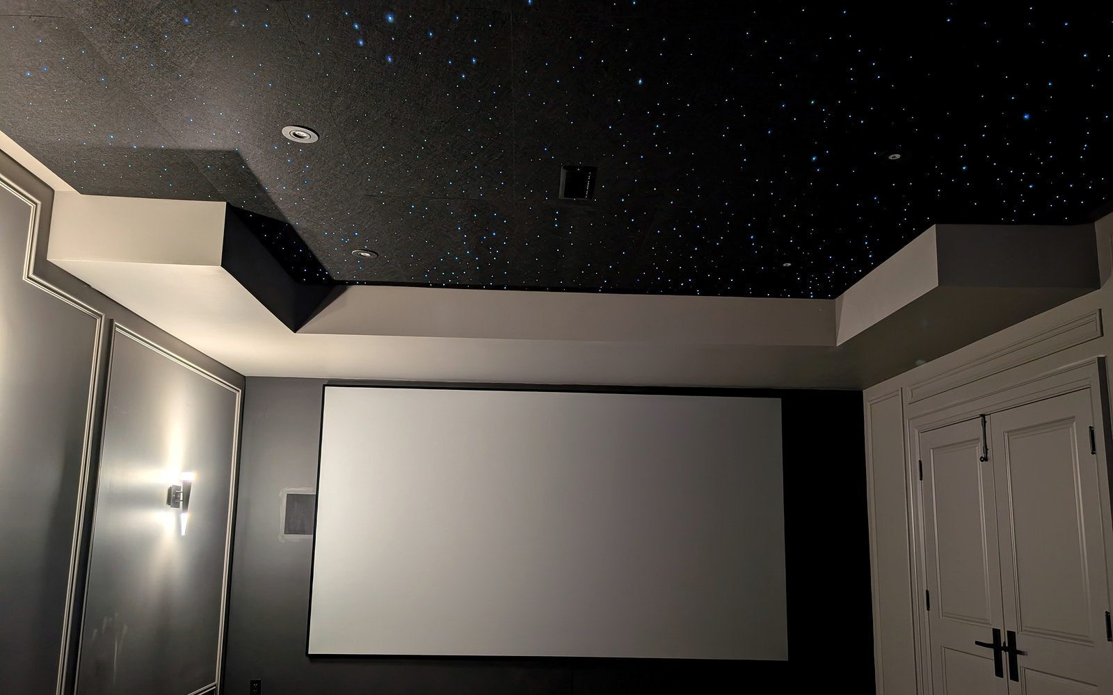 Wide home theater screen beneath a dense Starlight Ceiling