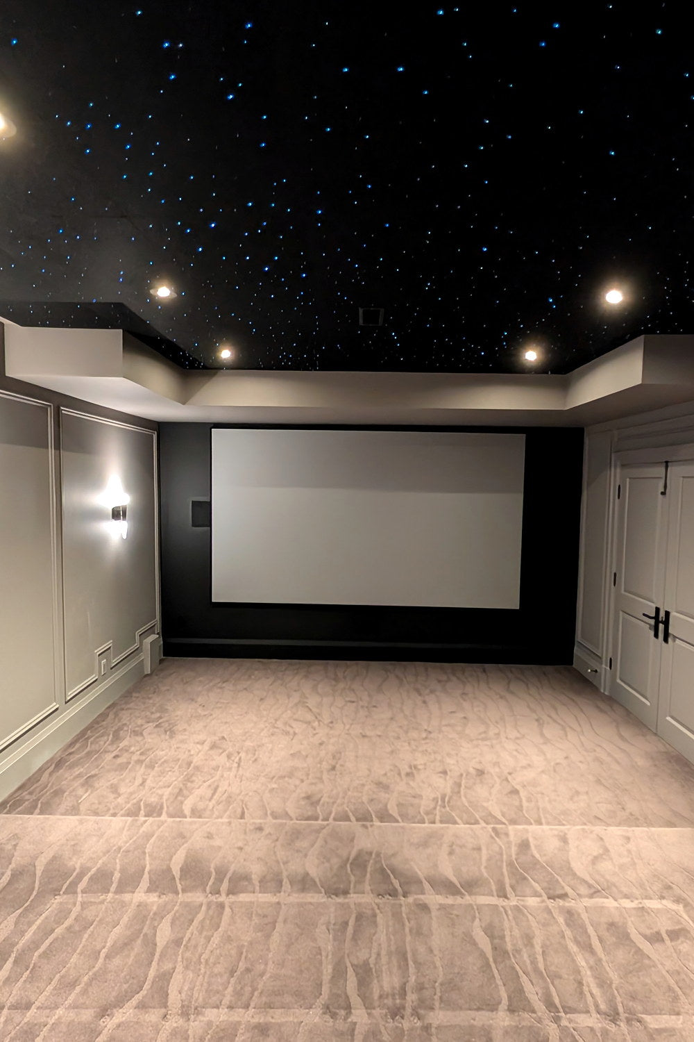 Full-height view of a home theater and its star-filled ceiling