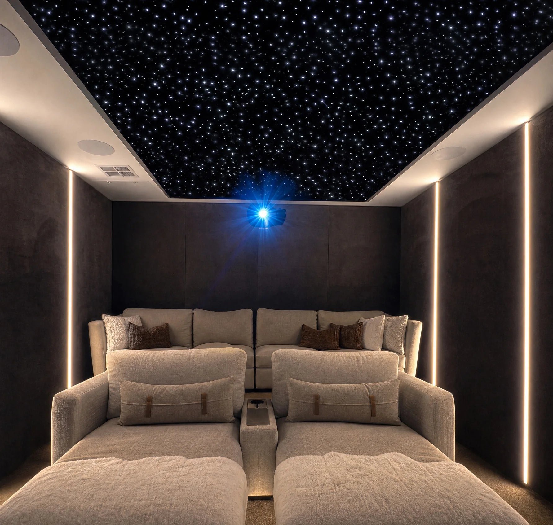 Cozy gray media room with cream lounge seating and a recessed starlight ceiling